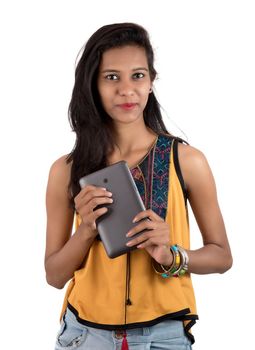 Portrait of a happy young girl using mobile phone isolated over white background