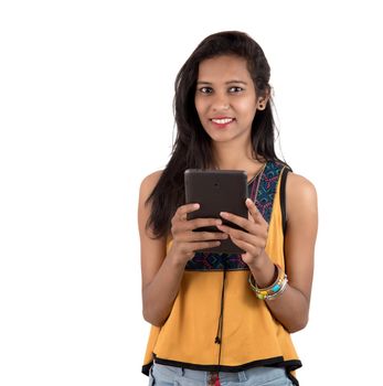 Portrait of a happy young girl using mobile phone isolated over white background