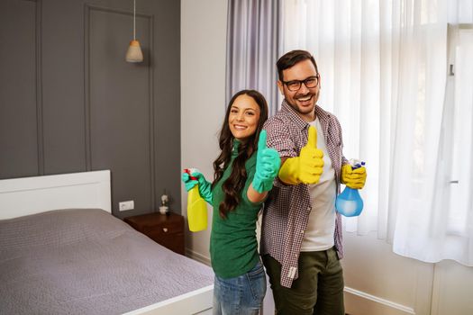 Young happy couple is ready for cleaning their apartment.