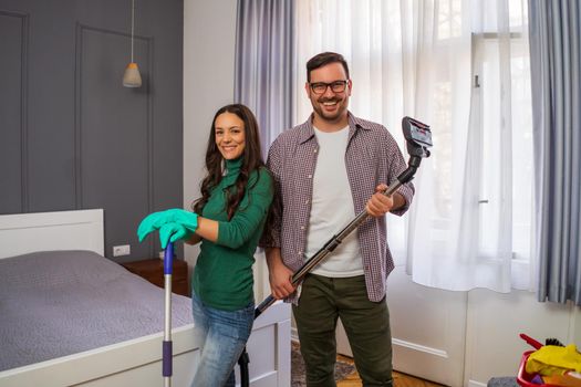 Young happy couple is ready for cleaning their apartment.