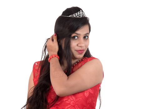 Young girl in red dress posing on white background