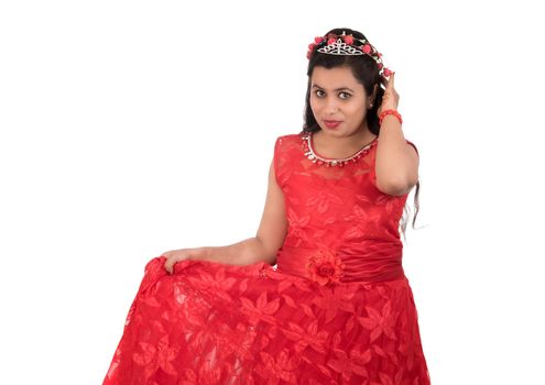 Young girl in red dress posing on white background