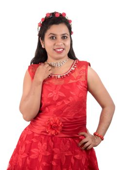 Young girl in red dress posing on white background