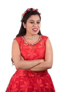 Young girl in red dress posing on white background