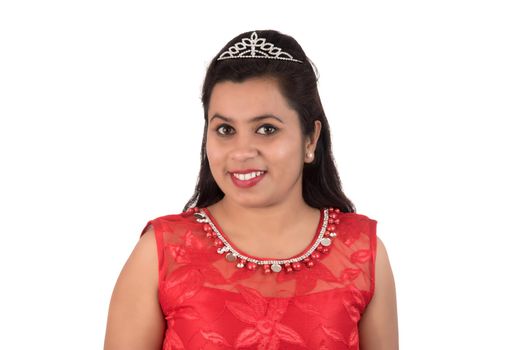 Young girl in red dress posing on white background