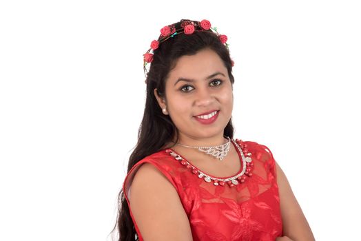 Young girl in red dress posing on white background