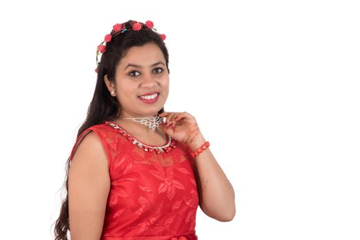 Young girl in red dress posing on white background