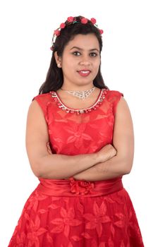 Young girl in red dress posing on white background