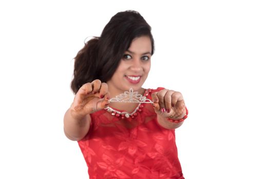 Young girl in red dress posing on white background