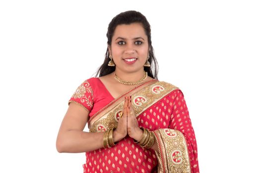 Beautiful Indian girl in a tradition sari with welcome expression (inviting), greeting Namaste