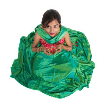 Portrait of a Indian Traditional Girl holding Diya, Girl Celebrating Diwali or Deepavali with holding oil lamp during festival of light on white background