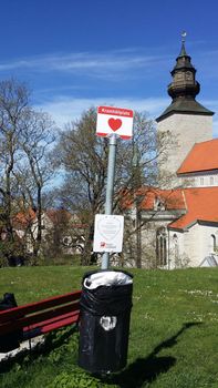 Visby, Sweden, May 5, 2019. The bus stop of love and hugs in Visby in Gotland in Sweden with a view of the cathedral in the background