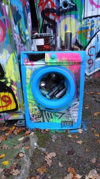 Stockholm, Snosatra, October 28, 2020. A colored washing machine used as a basket to throw away the coloring spray cans used during the day