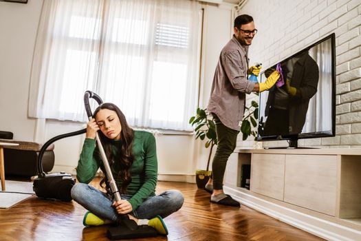 Woman is tired of cleaning the apartment.