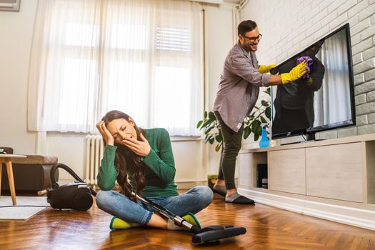 Woman is tired of cleaning the apartment.