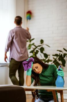 Woman is tired of cleaning the apartment.