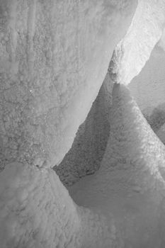 A fabulous artificial ice cave, the walls are covered with snow and illuminated. Frozen ice and cold inside