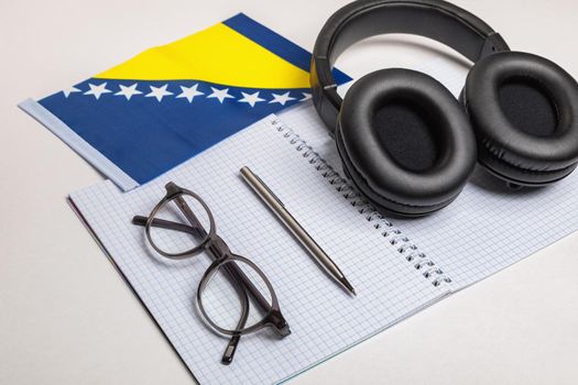 Learning foreign languages in Bosnia and Herzegovina with audio recordings and headphones. Notepad, glasses, pen.