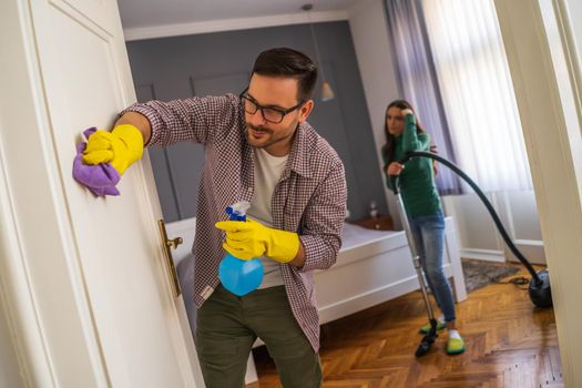 Young couple is cleaning their apartment. They are tired.