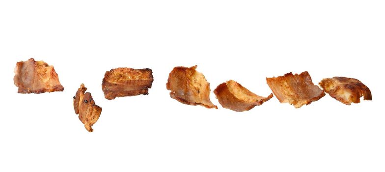 various small fried bacon pieces isolated on white background