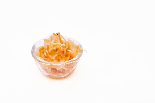 Sauerkraut in a glass bowl on a white background