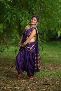 Indian Beautiful young girl in Traditional Saree posing outdoors