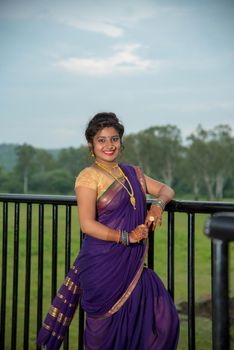 Beautiful Indian young girl in Traditional Saree posing outdoors