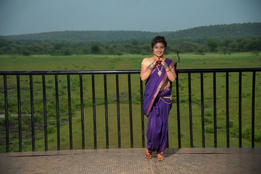 Beautiful Indian young girl in Traditional Saree posing outdoors