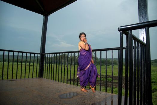 Beautiful Indian young girl in Traditional Saree posing outdoors