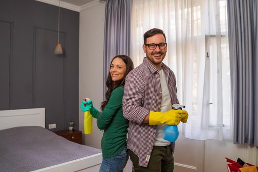 Young happy couple is ready for cleaning their apartment.