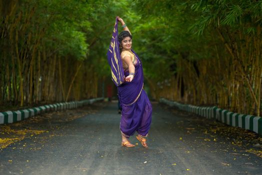 Indian Traditional Beautiful young girl in saree posing outdoors