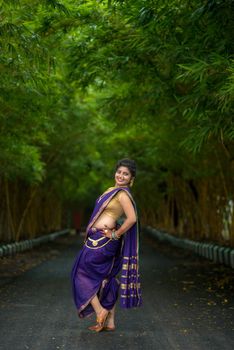 Indian Traditional Beautiful young girl in saree posing outdoors