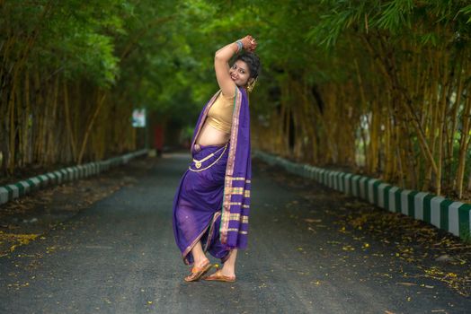 Indian Traditional Beautiful young girl in saree posing outdoors