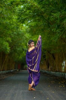 Indian Traditional Beautiful young girl in saree posing outdoors