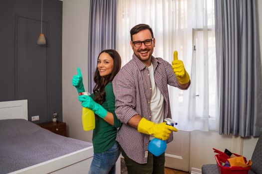 Young happy couple is ready for cleaning their apartment.