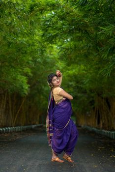 Indian Traditional Beautiful young girl in saree posing outdoors