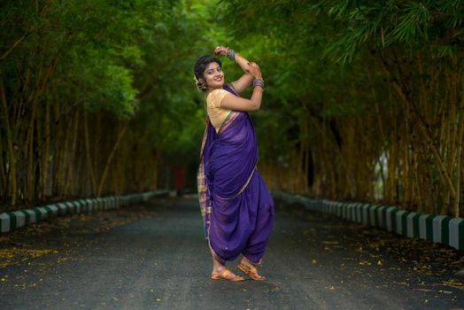 Indian Traditional Beautiful young girl in saree posing outdoors