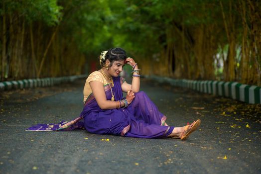 Indian Traditional Beautiful young girl in saree posing outdoors