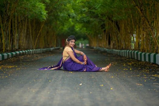 Indian Traditional Beautiful young girl in saree posing outdoors