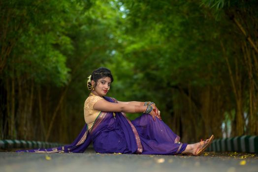 Indian Traditional Beautiful young girl in saree posing outdoors