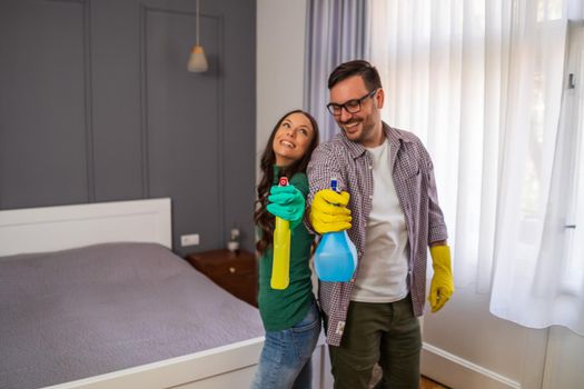 Young happy couple is ready for cleaning their apartment.