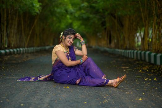 Indian Traditional Beautiful young girl in saree posing outdoors