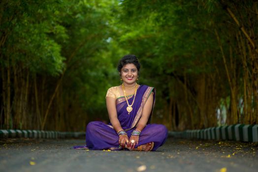 Indian Traditional Beautiful young girl in saree posing outdoors