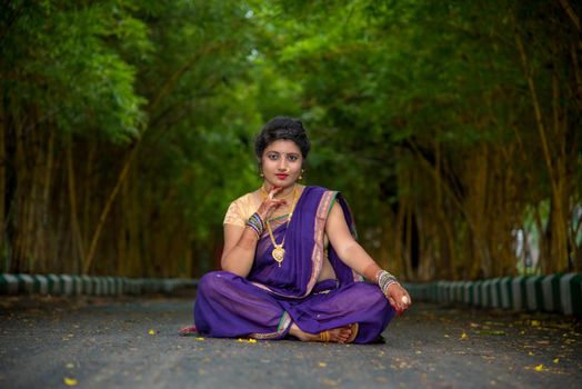 Indian Traditional Beautiful young girl in saree posing outdoors