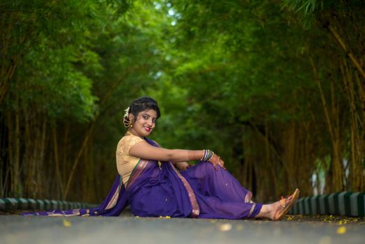 Indian Traditional Beautiful young girl in saree posing outdoors