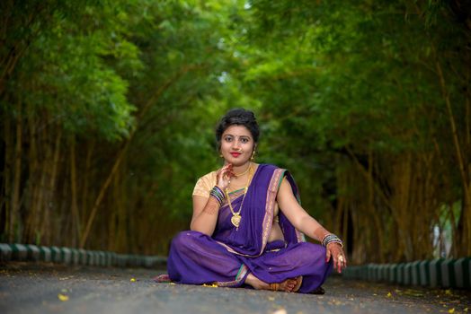 Indian Traditional Beautiful young girl in saree posing outdoors