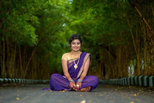 Indian Traditional Beautiful young girl in saree posing outdoors