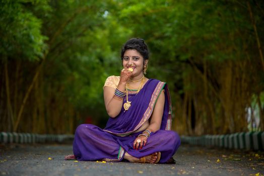 Indian Traditional Beautiful young girl in saree posing outdoors