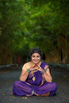 Indian Traditional Beautiful young girl in saree posing outdoors