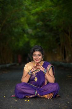 Indian Traditional Beautiful young girl in saree posing outdoors